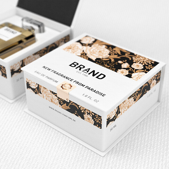 Perfume packaging with tamper-evident seal to prevent substitution and refilling, ensuring customers receive an original product. White and gold floral design with ‘Brand - New Fragrance from Paradise, Eau de Parfum, 1.0 FL. OZ.’
